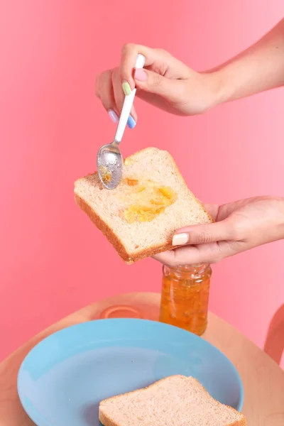 Asian Woman Filling Orange Jam Sliced Bread Pink Background — Stock Photo, Image