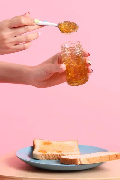 Asian Woman Filling Orange Jam Sliced Bread Pink Background — Stock Photo, Image