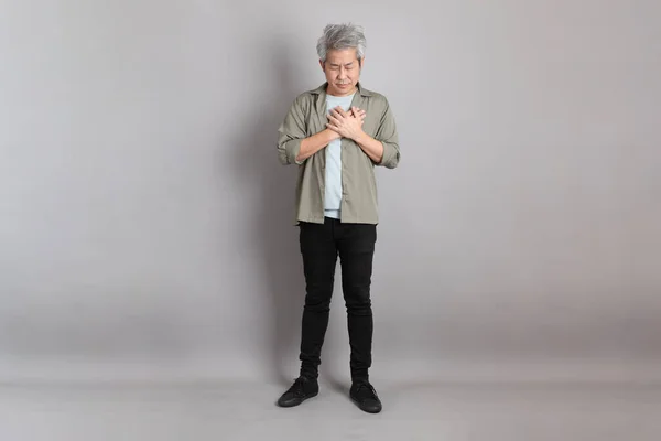 stock image The 40s Asian man with smart casual clothes standing on the grey background. 