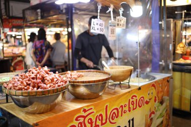 Bangkok, Thailand - November 19th, 2023:  Fried fish balls and fried sausage  in Thailand night market. clipart