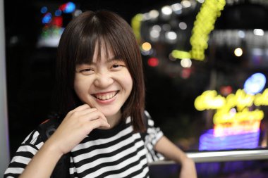 Smiling Young asian woman  at the night market Bangkok, Thailand. City lifestyle, Staycation. Bokeh on background. Tourist clipart