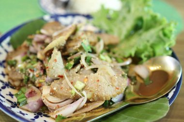 Tayland usulü ızgara domuz salatası tabakta servis edilir..