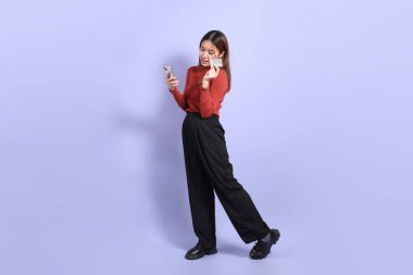 The young Southeast Asian woman in casual clothes, standing against a purple background. clipart