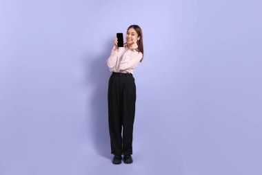 A young Southeast Asian woman in business clothes, standing against a purple background. clipart