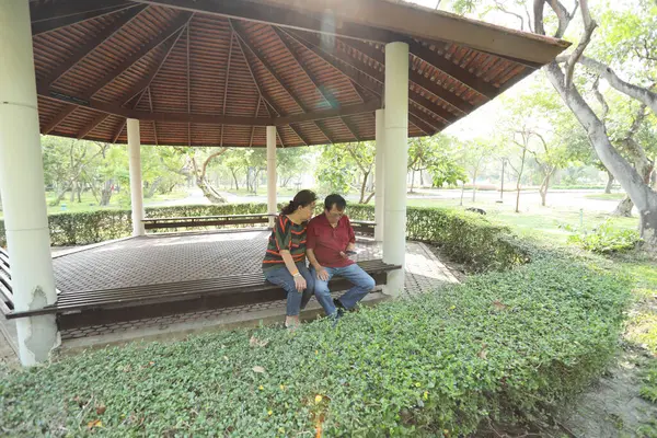 Doğu Asya 'nın son sınıf çifti parkta oturmuş dinleniyor..