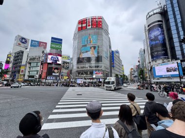 Tokyo, Japonya - 24 Mayıs 2025: İnsanların yeşil ışığın geçmesini beklediği kalabalık Shibuya geçidi, Shibuya, Tokyo, Japonya 'da bulunan ünlü kavşaktır..