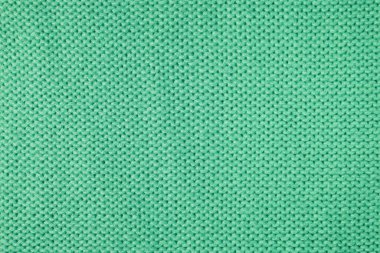 Yapışkan iplikten örülmüş yün kumaşın arka planını kapat. Pastel yeşili yün örgü dokusu. Soyut örgü forma arka planı. Kumaş soyut arkaplan, duvar kağıdı