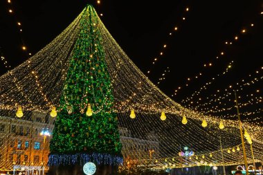 Şehrin Noel ağacının tatil ışıkları Central City Meydanı, Kyiv, Ukrayna 'da. Parlak tatil süslemeleri. Gece, akşam aydınlanması. Yeni yıl arkaplanı, dışarıda Noel kutlaması.