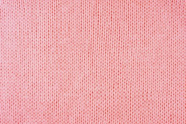 Yapışkan iplikten örülmüş yün kumaşın arka planını kapat. Pastel kırmızısı yün örgü dokusu. Soyut örgü forma arka planı. Kumaş soyut arkaplan, duvar kağıdı
