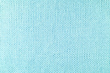 Yapışkan iplikten örülmüş yün kumaşın arka planını kapat. Pastel turkuaz renk yün örgü dokusu. Soyut örgü forma arka planı. Kumaş soyut arkaplan, duvar kağıdı