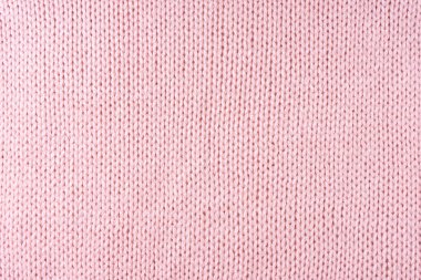 Yapışkan iplikten örülmüş yün kumaşın arka planını kapat. Pastel pembe yün örgü dokusu. Soyut örgü forma arka planı. Kumaş soyut arkaplan, duvar kağıdı