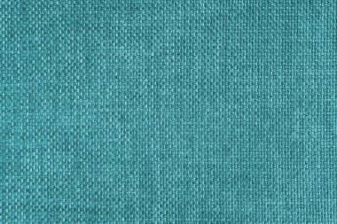 Jacquard woven upholstery, bright turquoise coarse fabric texture. Textile background, furniture textile material, wallpaper, backdrop. Cloth structure close up.