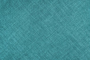 Jacquard woven upholstery, bright turquoise coarse fabric texture with diagonal weave lines. Textile background, furniture textile material, wallpaper, backdrop. Cloth structure close up.