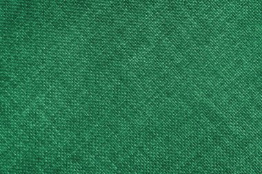 Jacquard woven upholstery, green coarse fabric texture with diagonal weave lines. Textile background, furniture textile material, wallpaper, backdrop. Cloth structure close up.