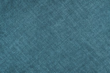 Jacquard woven upholstery, turquoise coarse fabric texture with diagonal weave lines. Textile background, furniture textile material, wallpaper, backdrop. Cloth structure close up.