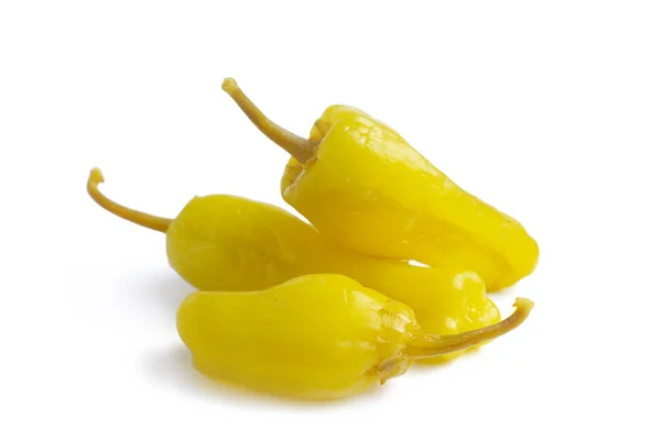 Three pickled yellow peppers, pepperoncini or friggitelli isolated on white background. Hot pepper marinated, brined. Traditional Italian and greek cuisine, ingredient for salad, pasta, sauce.