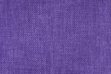 Jacquard woven upholstery, bright purple coarse fabric texture. Textile background, furniture textile material, wallpaper, backdrop. Cloth structure close up.