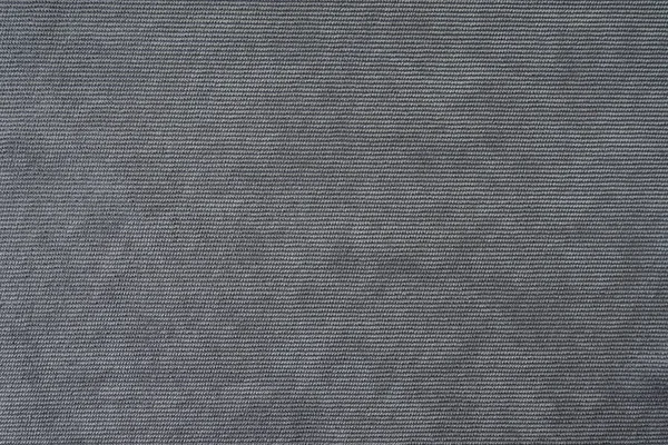 Texture background of velours gray fabric. Upholstery velveteen texture fabric, corduroy furniture textile material, design interior, decor. Ridge fabric texture close up, backdrop, wallpaper.
