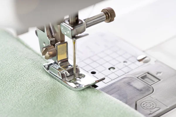 現代のミシンは緑の生地と糸で足を押すと マクロを閉じます 縫製プロセス服 カーテン ビジネス 手作り 廃棄物ゼロ リサイクル 修理の概念 — ストック写真