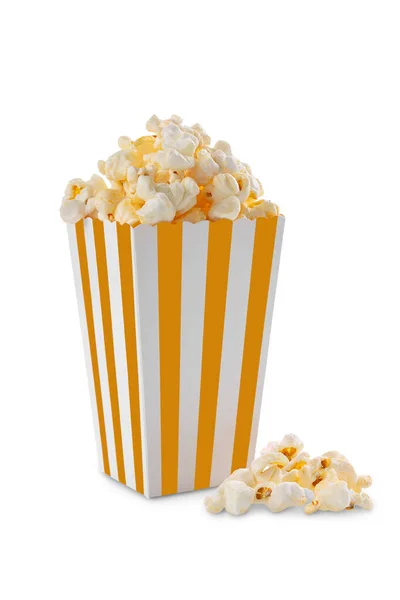 stock image Yellow white striped carton bucket with tasty cheese popcorn, isolated on white background. Box with scattering of popcorn grains. Fast food, movies, cinema and entertainment concept.