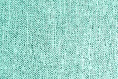 Jacquard woven upholstery, turquoise coarse fabric texture. Textile background, furniture textile material, wallpaper, backdrop. Cloth structure close up.