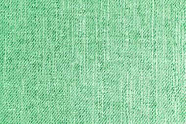 Jacquard woven upholstery, green coarse fabric texture. Textile background, furniture textile material, wallpaper, backdrop. Cloth structure close up.