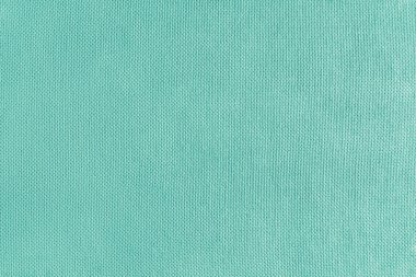 Turkuaz kadife kumaşın dokusu. Tekstil yapısı, kumaş yüzeyi, Jacquard malzemesinin yakın çekim dokusu. Döşemeler, perdeler, arka plan, duvar kağıtları..
