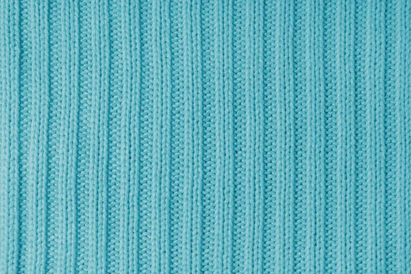 Jersey textile background , turquoise striped knitted fabric. Woolen knitwear, sweater, pullover surface texture,  textile structure, cloth surface, weaving of knitwear material. Wallpaper, backdrop.
