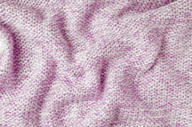 Pembe ve beyaz renkli melanj, kaşmir yün kumaş dokusu örüyor. Buruşuk, buruşuk örgü kumaş, tekstil yapı, kumaş yüzey, örgü kumaş dokuma.