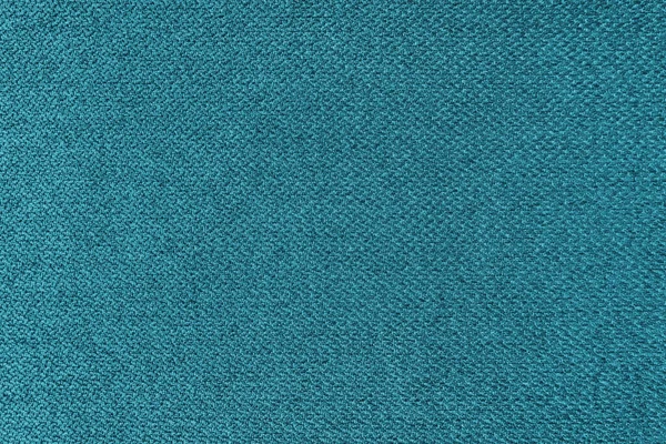 Textile background, turquoise coarse fabric texture, jacquard woven upholstery, furniture textile material, wallpaper, backdrop. Cloth structure close up.