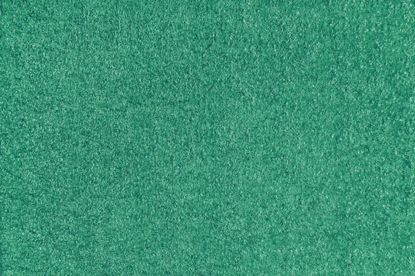 Texture background of green fabric. Upholstery jacquard texture cloth, boucle furniture textile material, design interior, decor. Ridge fabric texture close up, backdrop, wallpaper.