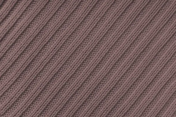Jersey textile background , brown diagonal striped knitted fabric. Woolen knitwear, sweater, pullover surface texture, textile structure, cloth surface, weaving of knitwear material