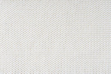 Örgü örülmüş yün kumaş kumaşının arka planını kapatın, beyaz yün örgü dokusu. Kazak, kazak örgü forma arka planı. Kumaş soyut arkaplan, duvar kağıdı