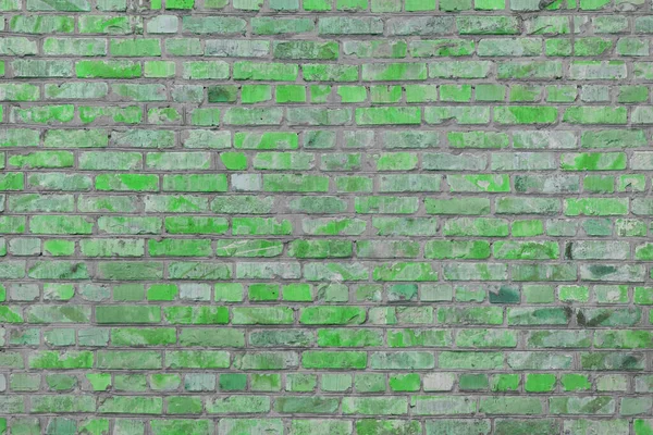 Old green painted brick wall texture background, architectural element, masonry, brickwork. Backdrop, wallpaper.