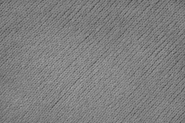 Gray knitted woolen jersey fabric with diagonal weaving, sweater, pullover texture background. Fabric abstract backdrop, cloth wallpaper