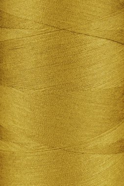 Makaradaki sarı renk ipliklerinin dokusu yakın, makro. İplikler dikiliyor bobbin soyut arkaplan, duvar kağıdı, arkaplan.