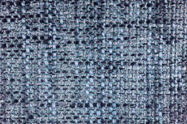 Kabataslak dokuma makrosundan yapılmış mavi jakquard kumaş dokusu, yakından. Karışık renk, melanj bezi. Ev yapımı tekstil, döşeme, perde dekorasyonu ve giysi malzemesi. Arkaplan, duvar kağıdı, arkaplan.