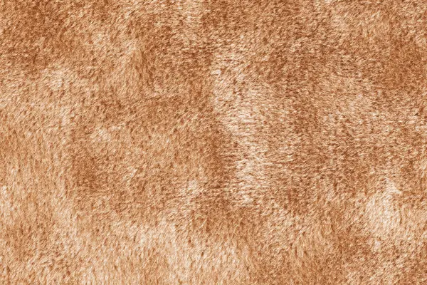 stock image Faux fur, velours orange fabric or cloth. Fluffy fabric texture of artificial fur textile material. Canvas background. Decorative fabric for curtain, furniture, upholstery, walls, clothes.