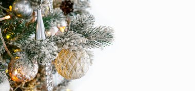 Decorated Christmas tree with frosted branches, shimmering ornaments and shining lights isolated on white background. Festive atmosphere for holiday celebrations. Banner, header with copy space clipart