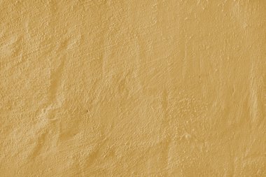 Stucco alçı yüzey, fırça darbesi arka plan, yakın plan, sarı boyanmış çimento makro doku, beton duvar dokusu. Duvar kağıdı, arkaplan, mimari tasarım ögesi