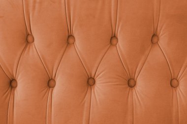 Capitone, elmas işlemeli yumuşak kumaşlı, düğmeli dekoratif arka plan. Klasik retro Chesterfield tarzı, lüks döşeme turuncu dokuma, mobilya, duvar, yatak başlığı, kanepe, kanepe