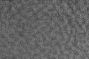 Sahte kürk, kadife gri kumaş ya da dalgalı efektli kumaş. Yapay kürklü yumuşacık kumaş kumaş, kumaş dokusu makrosu. Tuvalin arka planı. Perde, döşeme ve kıyafetler için dekoratif kumaş.