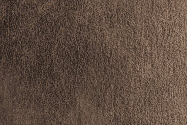 Yaklaş, kahverengi süet kumaşın makro yapısı soyut kabartmalı eski püskü, dağınık dokusu var. Döşeme, dekoratif kumaş yapı, ev dekorasyonu için tuval. Arkaplan, arkaplan, duvar kağıdı.