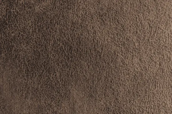 Yaklaş, kahverengi süet kumaşın makro yapısı soyut kabartmalı eski püskü, dağınık dokusu var. Döşeme, dekoratif kumaş yapı, ev dekorasyonu için tuval. Arkaplan, arkaplan, duvar kağıdı.