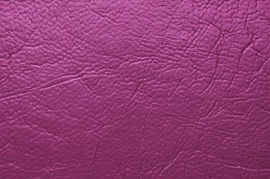 Yakın çekim, pembe parlak doğal deri, deri kaplama, kabartmalı desenli sanatsal deri yüzeyi. Arkaplan, duvar kağıdı, arkaplan