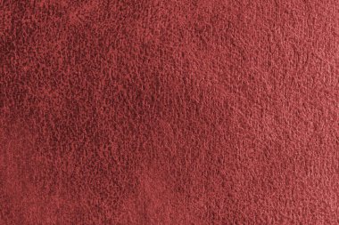 Yaklaş, soyut kabartmalı, dağınık desenli kırmızı süet kumaşlı makro yapı. Döşeme, dekoratif kumaş yapı, ev dekorasyonu için tuval. Arkaplan, arkaplan, duvar kağıdı.