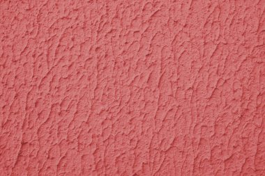 Kalıplı kırmızı boyalı duvar, kaba sıva, alçı duvar dokusu. Canlı arkaplan, duvar kağıdı, arkaplan, tasarım ögesi.