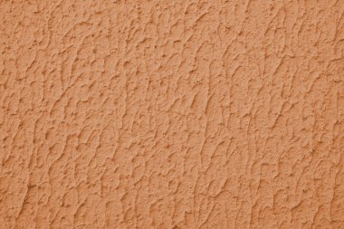 Kapalı desenli turuncu renkli duvar, kaba sıva, alçı duvar dokusu. Canlı arkaplan, duvar kağıdı, arkaplan, tasarım ögesi.