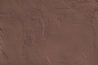 Yaklaş, kahverengi desenli, sert alçılı, beton yüzey dokusuyla kaplanmış duvar. Soyut arkaplan, tasarım için arkaplan, duvar kağıdı sanatı veya dekorasyon projeleri.