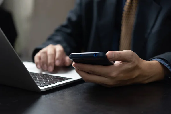 stock image Businessman using mobile smart phone and computer laptop in modern office.Business Technology internet digital concept.